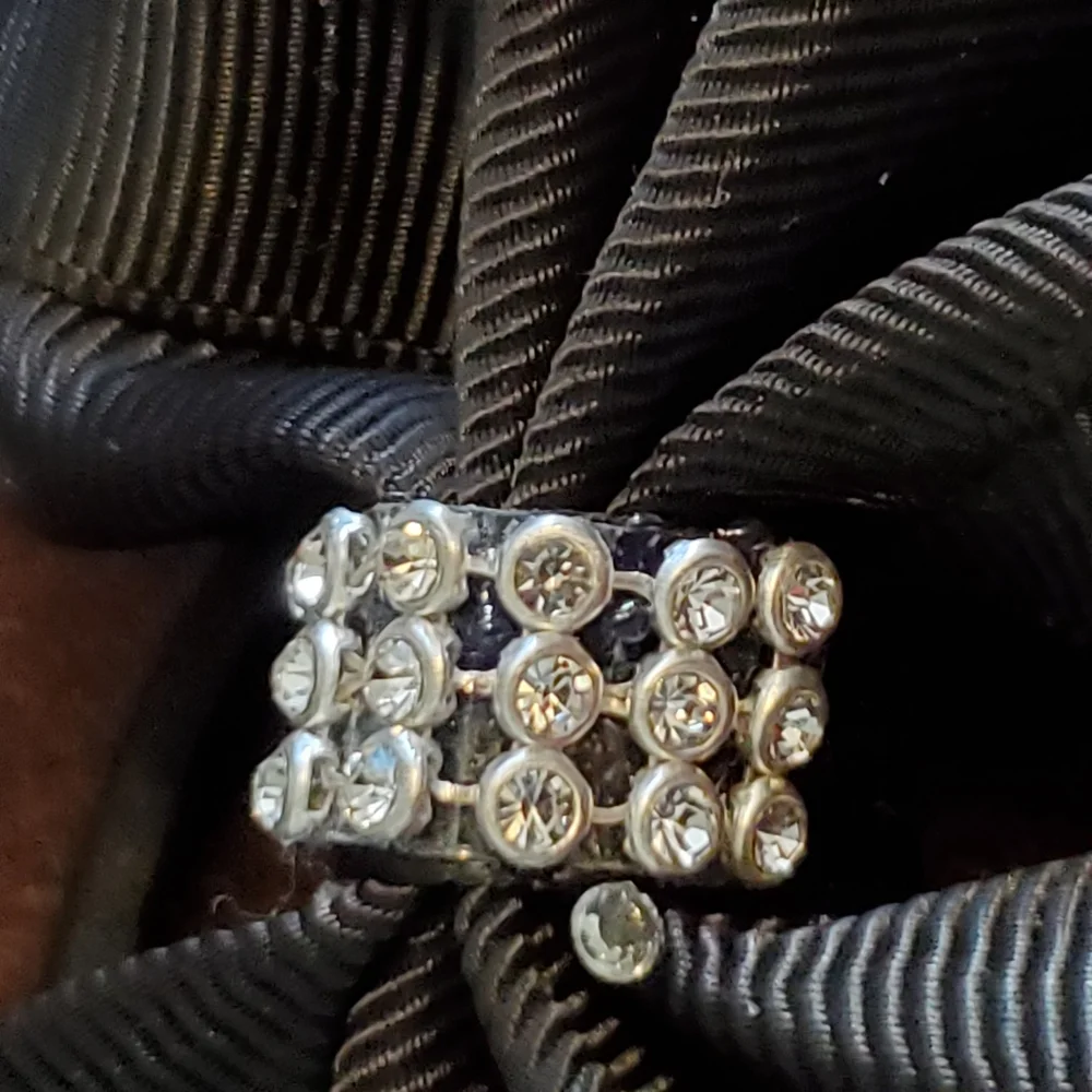 Black ponytail holder with bow and clear rhinestones and studs